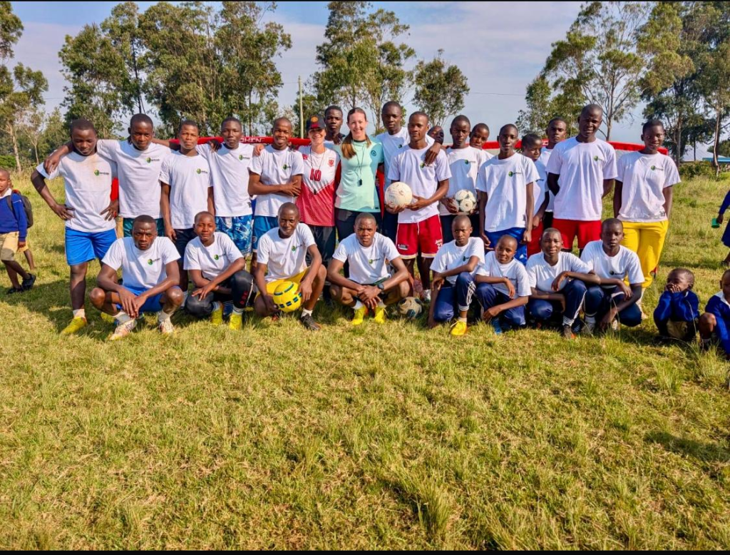 Volunteers and young players at the sports camp